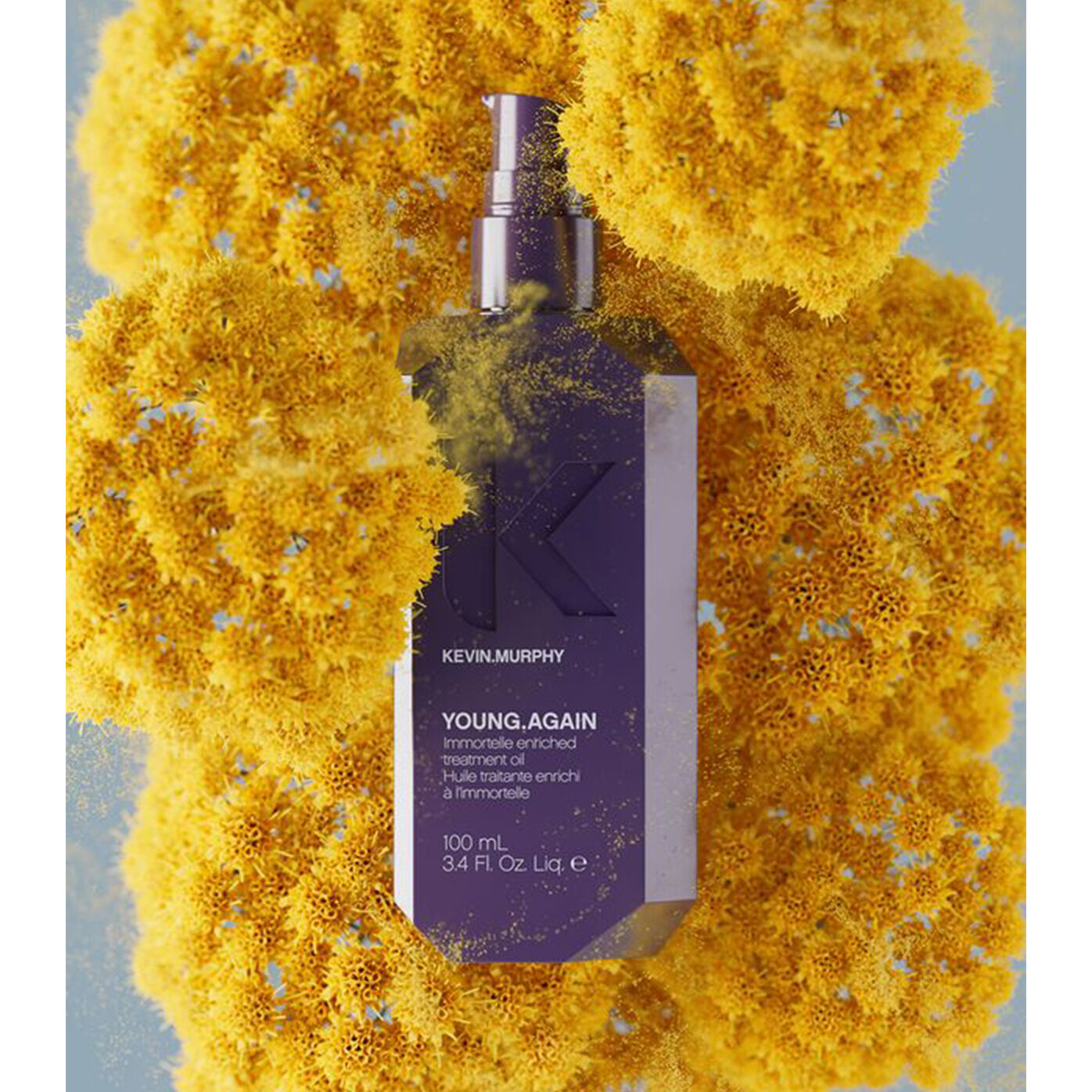 YOUNG.AGAIN oil bottle surrounded by yellow flowers with powder effect